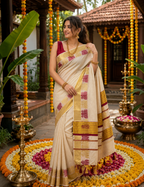 House Of Paramya off-white Kerala cotton Kasavu saree with maroon and gold lotus border worn by a woman outdoors
