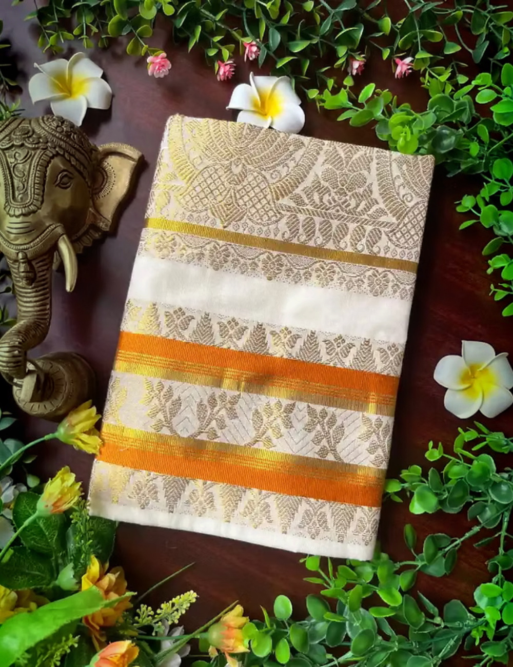 House Of Paramya off-white cotton Kasavu saree with golden lotus jacquard and vibrant orange contrast border