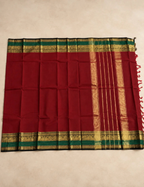 House Of Paramya maroon Chettinad cotton saree with bottle green border, antique gold zari peacock and floral motifs.