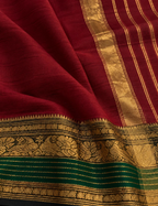 House Of Paramya maroon Chettinad cotton saree with a bottle green border featuring antique gold zari peacock motifs.