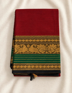 House Of Paramya maroon Chettinad cotton saree with a bottle green border featuring antique gold zari peacock motifs.