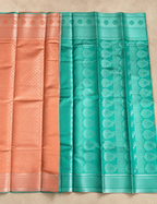 House Of Paramya rose gold and teal Banarasi silk saree featuring a diamond lattice pattern and woven paisley border.