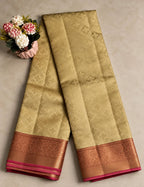 House Of Paramya beige Kanchipuram silk saree with intricate zari border and pink trim, displayed on a neutral surface.