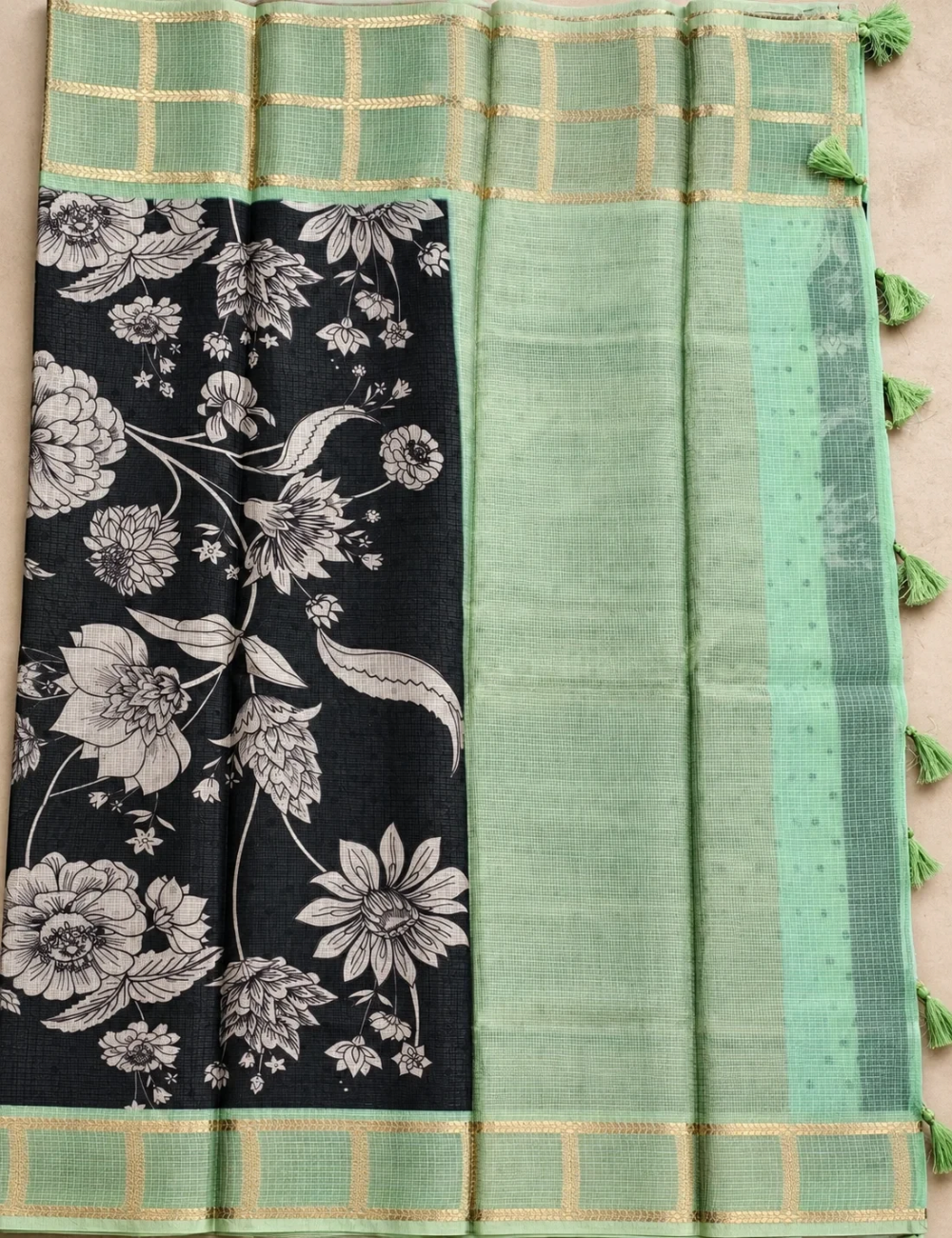 House Of Paramya black soft Kota silk saree with floral print and sage green zari check border and tassel pallu.
