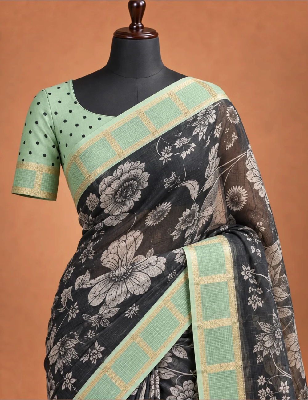 House Of Paramya black soft Kota silk saree with floral print and sage green zari check border on a mannequin