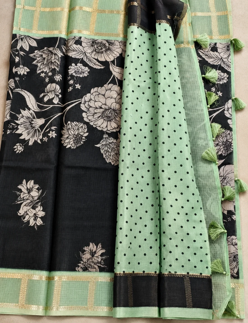 House Of Paramya black soft Kota silk saree with floral print and sage green zari check border and tassel pallu