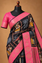 House Of Paramya black georgette saree with traditional prints, pink border, stone work, and matching blouse piece.