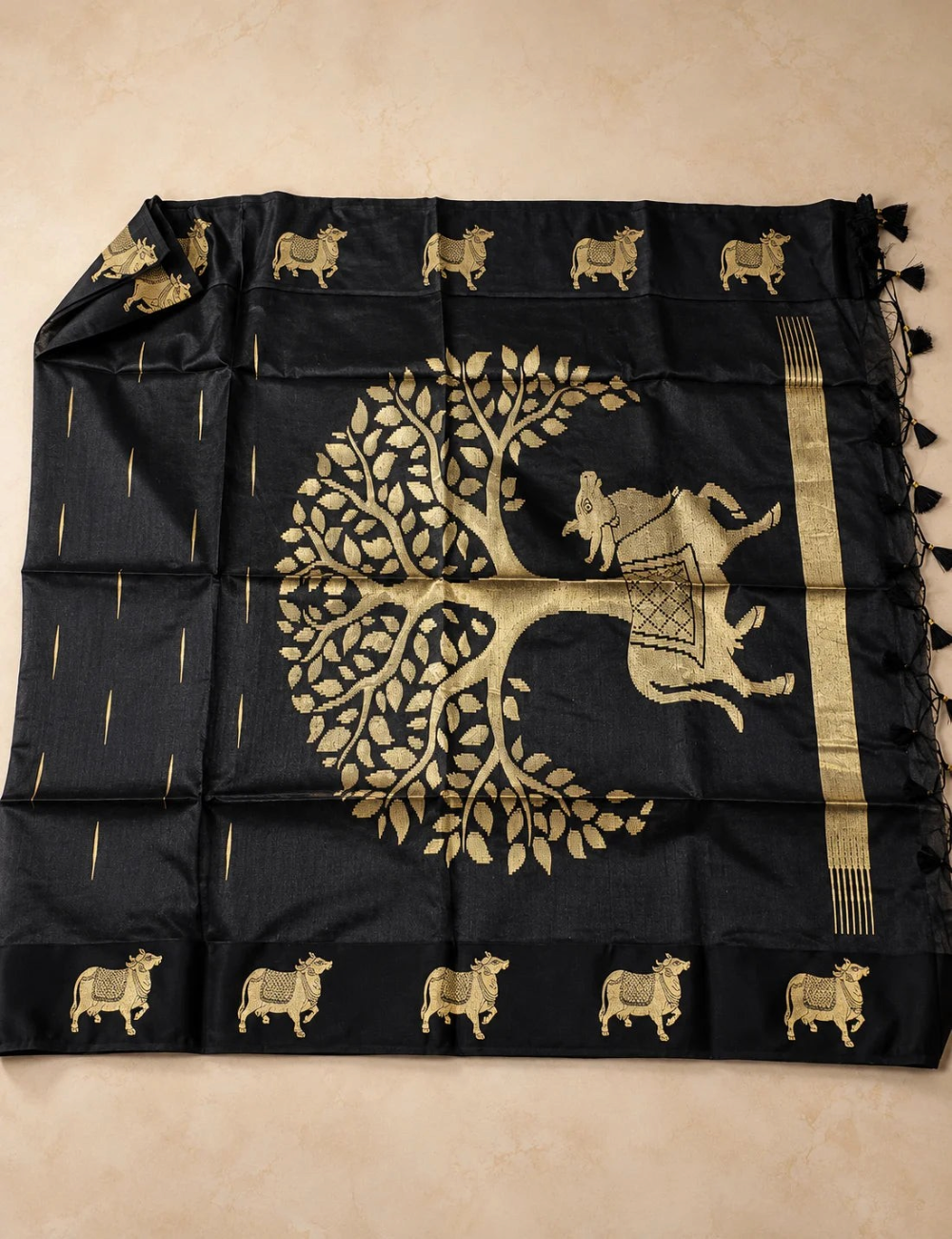 House Of Paramya black raw tussar silk saree featuring intricate gold zari Pichwai cow and tree motifs on the pallu.
