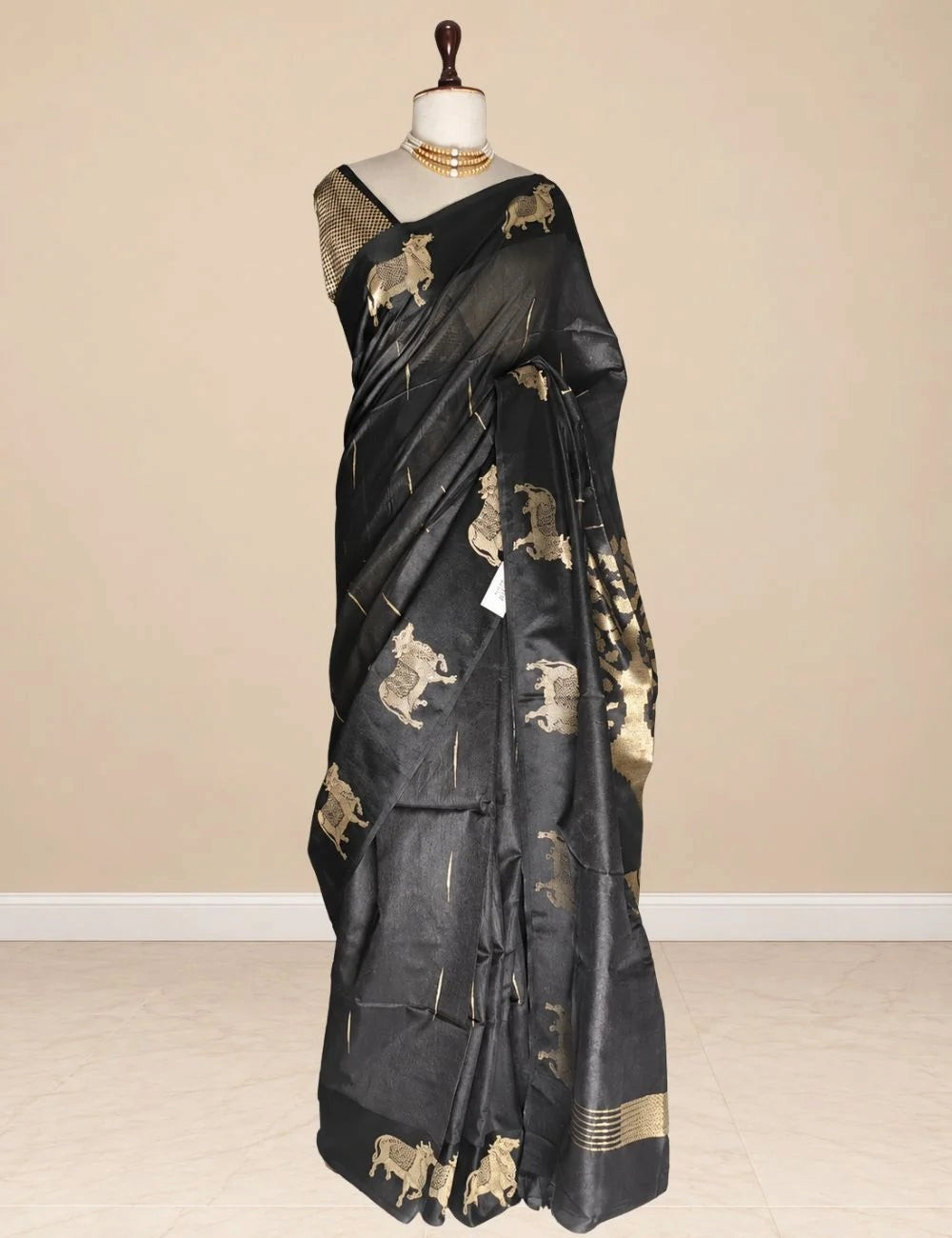 House Of Paramya black raw tussar silk saree featuring woven gold zari Pichwai cow motifs and a matching blouse piece.