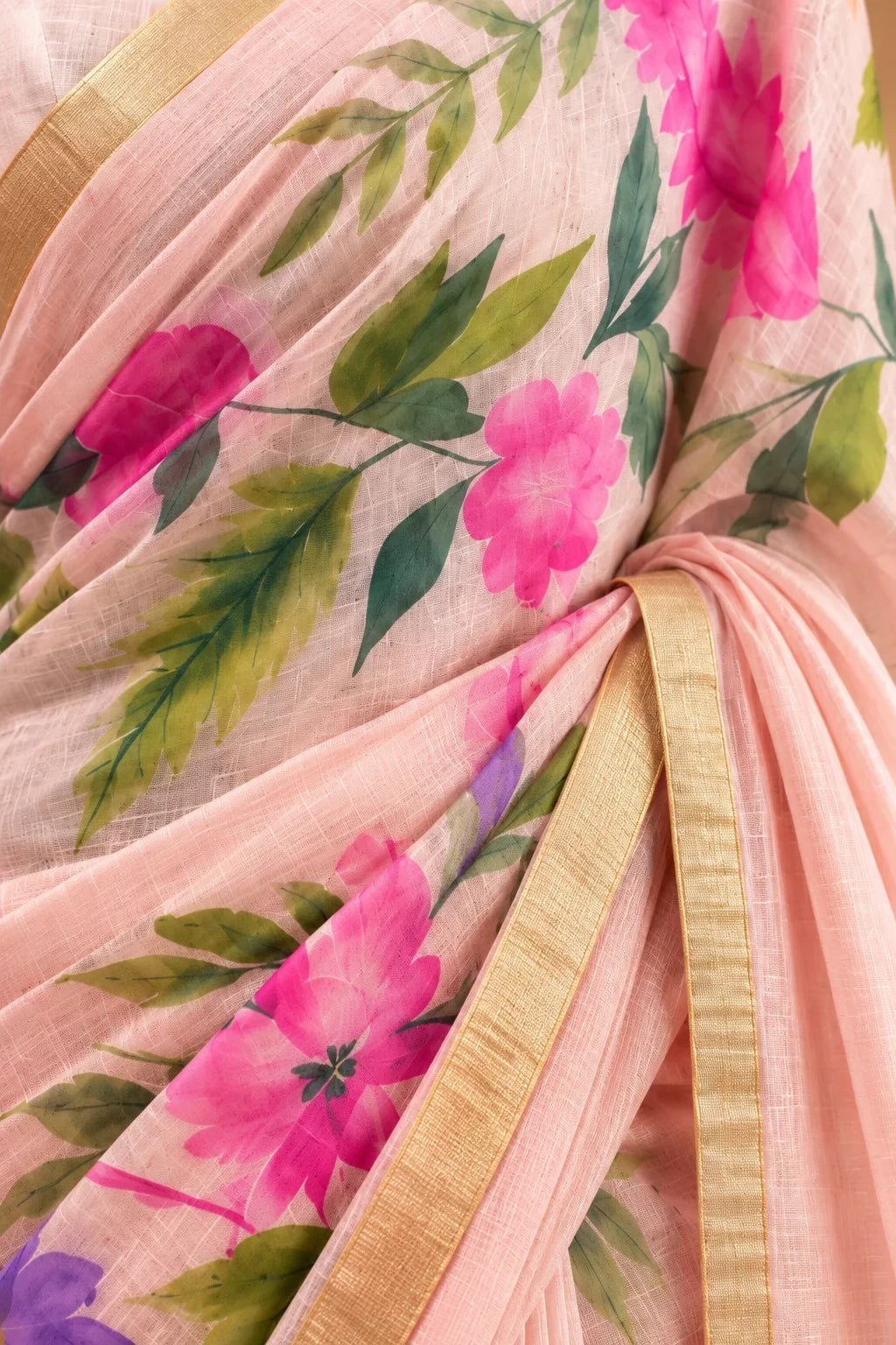 House Of Paramya blush pink linen saree with watercolor floral print in pink and green and a gold zari border