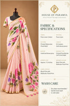 House Of Paramya blush pink pure linen saree with vibrant watercolor floral prints and a gold border on a mannequin.