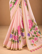 House Of Paramya blush pink linen saree with watercolor floral prints, gold border, and decorative tassel pallu.