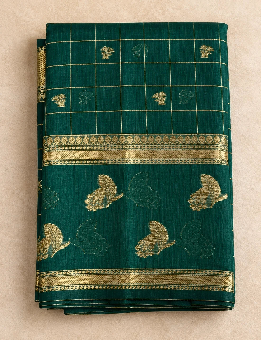 House Of Paramya bottle green raw silk saree featuring a gold checkered pattern, floral butis, and zari vine border.