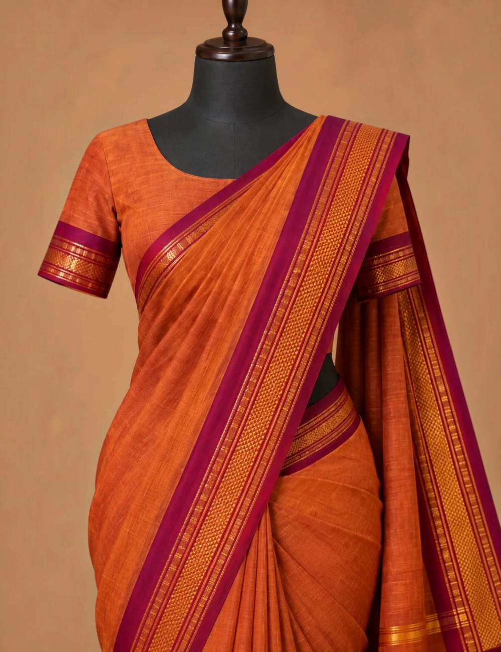 House Of Paramya burnt orange Chettinad cotton saree with a maroon border featuring intricate gold zari rosette motifs.