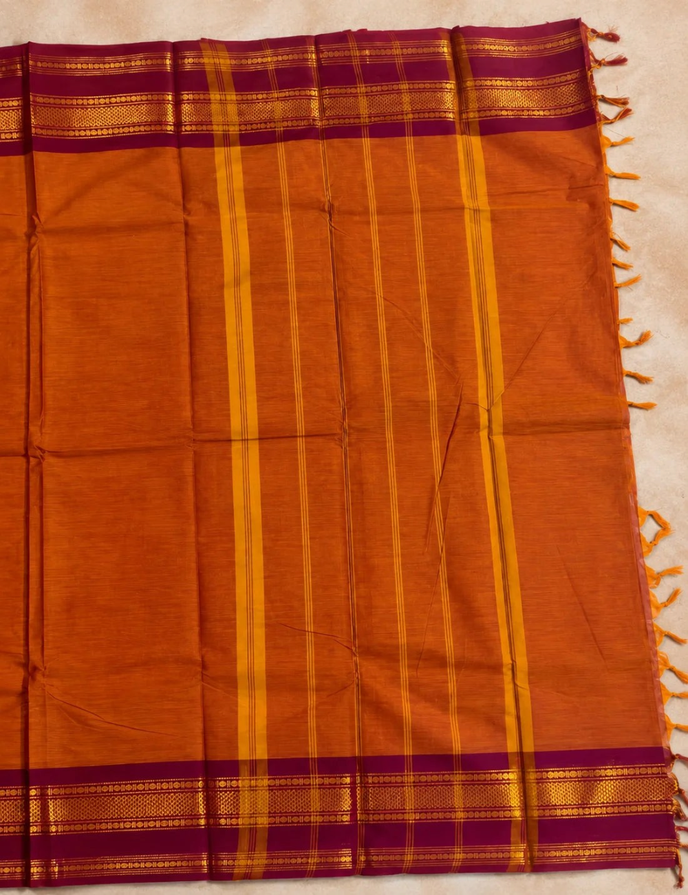 House Of Paramya burnt orange Chettinad cotton saree with a maroon border featuring gold zari rosette and diamond motifs.