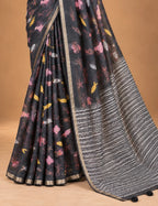 House Of Paramya charcoal linen saree with whimsical marine motifs and a black and white chevron striped pallu.