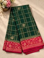 House Of Paramya emerald green georgette saree with gold checkered weave, floral zari motifs, and magenta pink border.