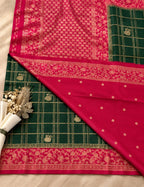 House Of Paramya emerald green georgette saree featuring a magenta pink floral zari border and gold checkered weave.