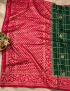 House Of Paramya emerald green georgette saree with a wide magenta pink floral zari border and gold checkered weave.