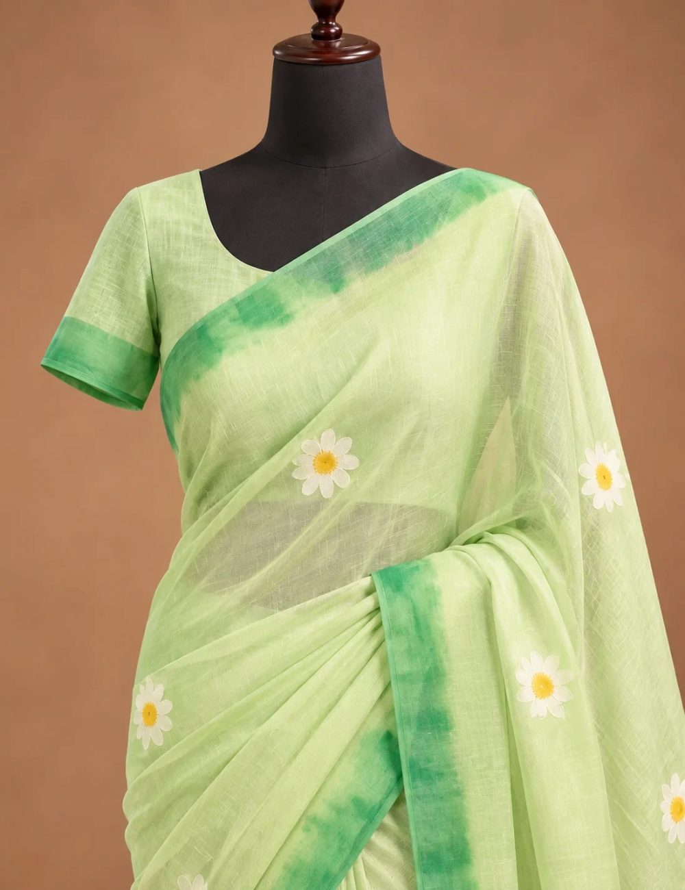 House Of Paramya pastel green linen cotton saree featuring a white and yellow daisy floral print and dark green border