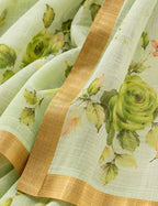 House Of Paramya pastel green linen cotton saree featuring a tonal monochrome rose print and a gold zari border.