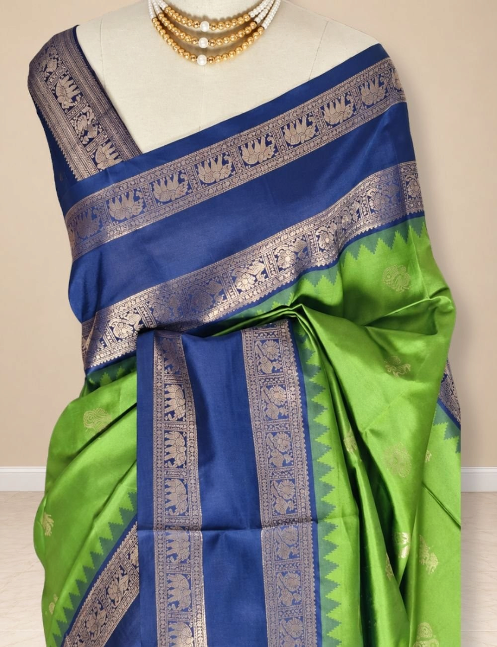 House Of Paramya parrot green semi soft silk saree with navy blue elephant border and peacock zari pallu on mannequin