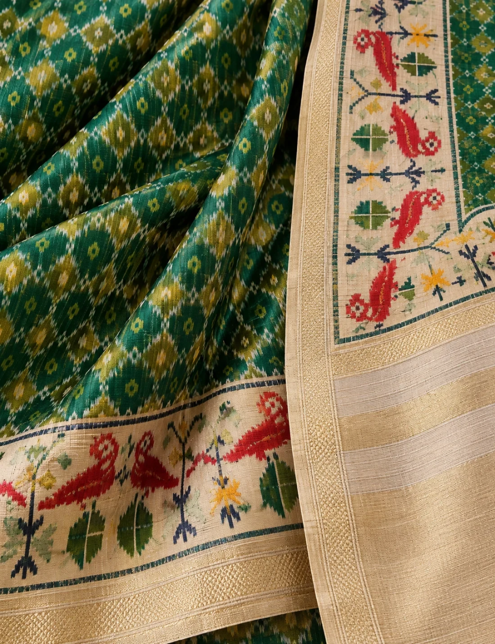 House Of Paramya green silk saree featuring a digital Patola print and a cream border with woven red parrot motifs.