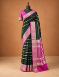 House Of Paramya dark green crepe silk saree with pink border and silver zari stripes on a mannequin