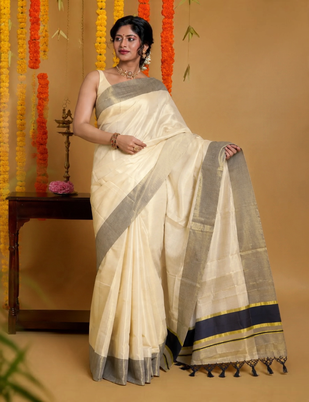 Model wearing a House Of Paramya ivory pure cotton Kasavu saree with a sea green border and gold zari accents.