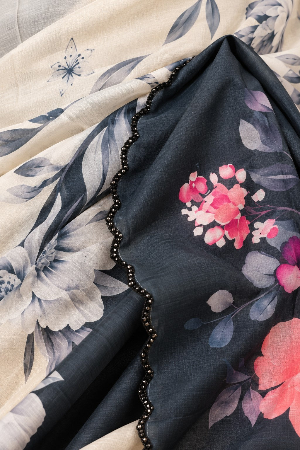 House Of Paramya ivory Japan satin saree featuring a floral print with pink roses and a charcoal scalloped border.