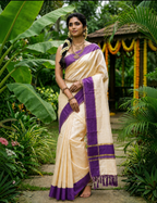 House Of Paramya ivory cotton saree with purple border and gold zari, worn by a woman in a lush garden setting.