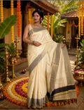 House Of Paramya ivory tissue Kasavu saree with grey-gold zari border and black stripe pallu worn by a woman