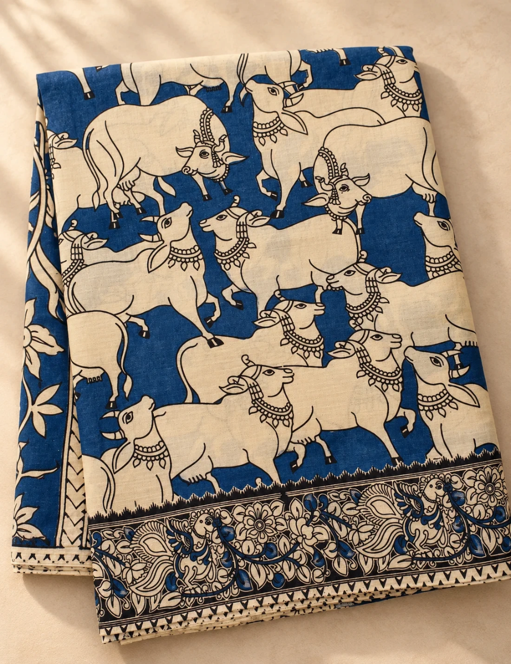 House Of Paramya beige and indigo mul cotton saree featuring hand-painted Kalamkari Pichwai cow motifs and border.