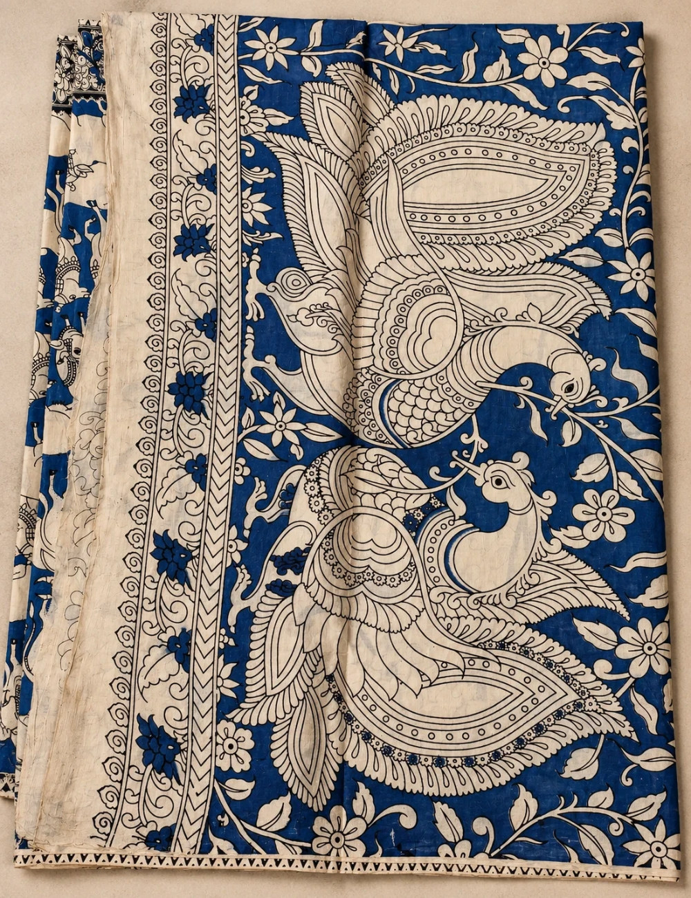 House Of Paramya beige and indigo mul cotton saree featuring intricate hand-painted Kalamkari Pichwai peacock motifs.