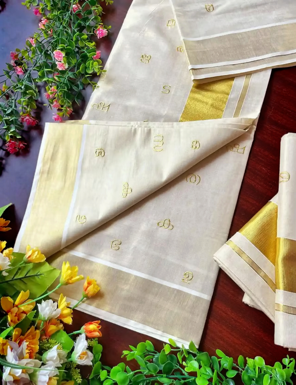 House Of Paramya off-white tissue silk Kasavu saree featuring gold Malayalam script Aksharamala motifs and border.