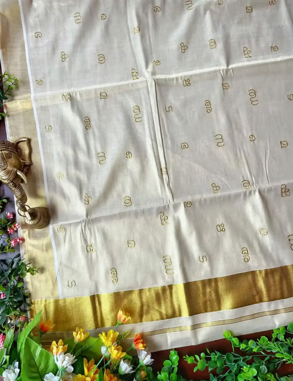 House Of Paramya off-white tissue silk saree with gold Kasavu border and intricate Malayalam script Aksharamala print