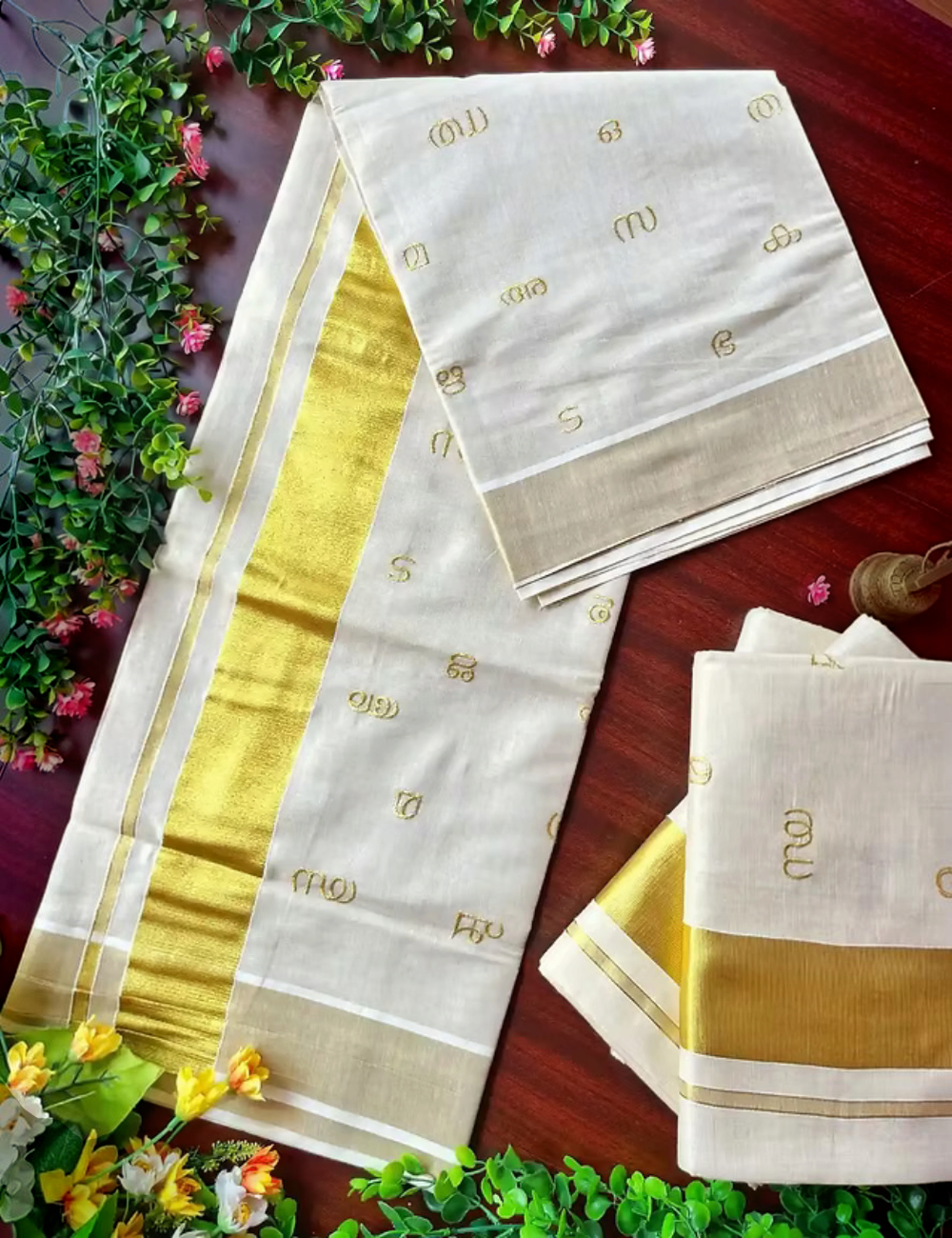 House Of Paramya off-white and gold tissue silk Kasavu saree featuring an elegant Malayalam script Aksharamala border.