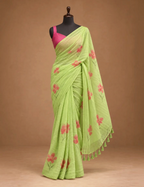 House Of Paramya lime green linen cotton saree with coral floral prints and a dark green gold border on a mannequin