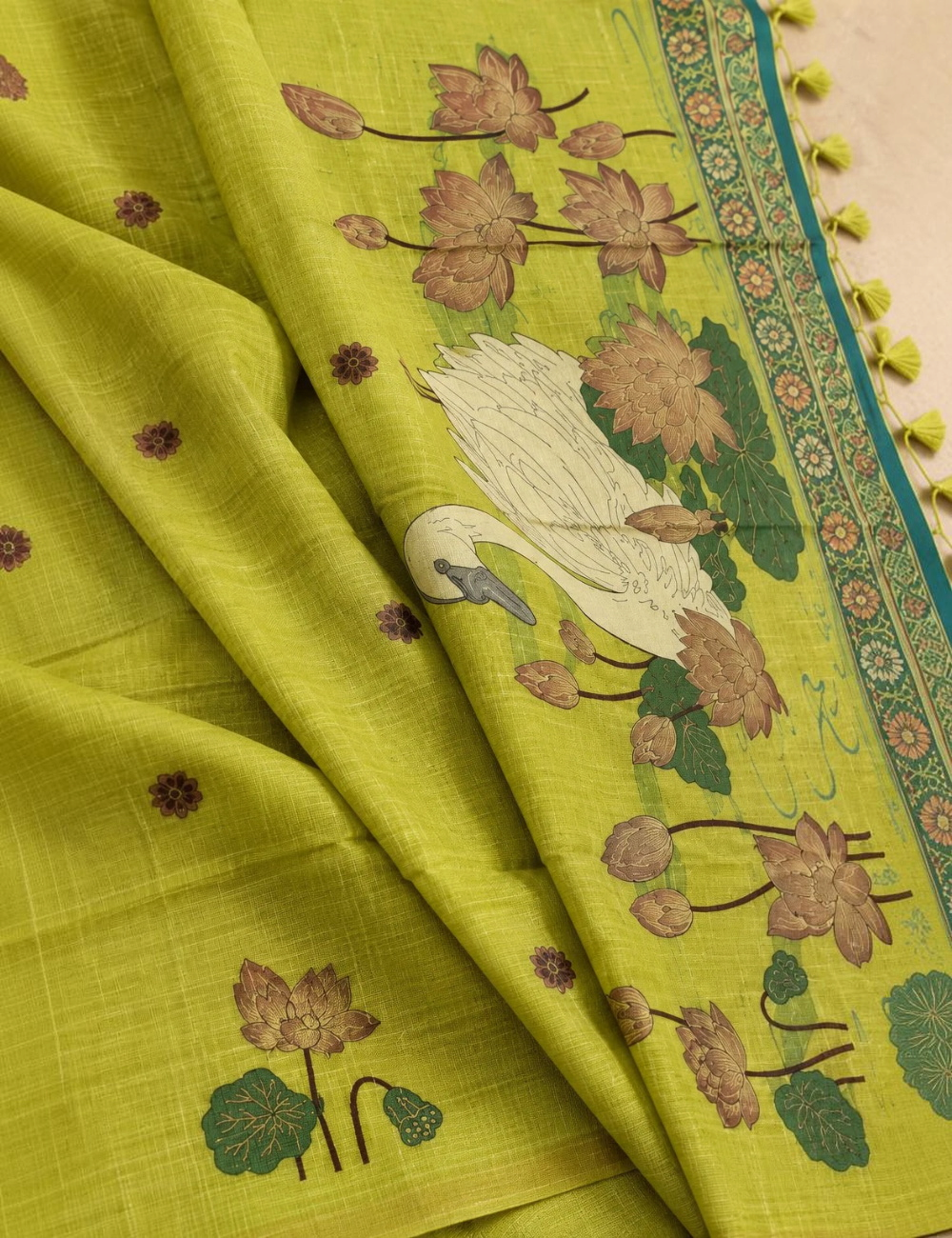 House Of Paramya lime green tussar silk cotton saree featuring woven lotus and swan motifs with a tassel pallu.