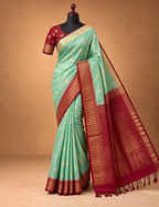 House Of Paramya mint green Kanchipuram silk saree with rani pink zari border and pallu on a mannequin