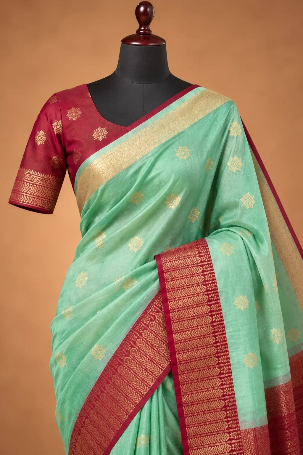 House Of Paramya mint green Kanchipuram silk saree with rani pink zari border and gold floral motifs on a mannequin