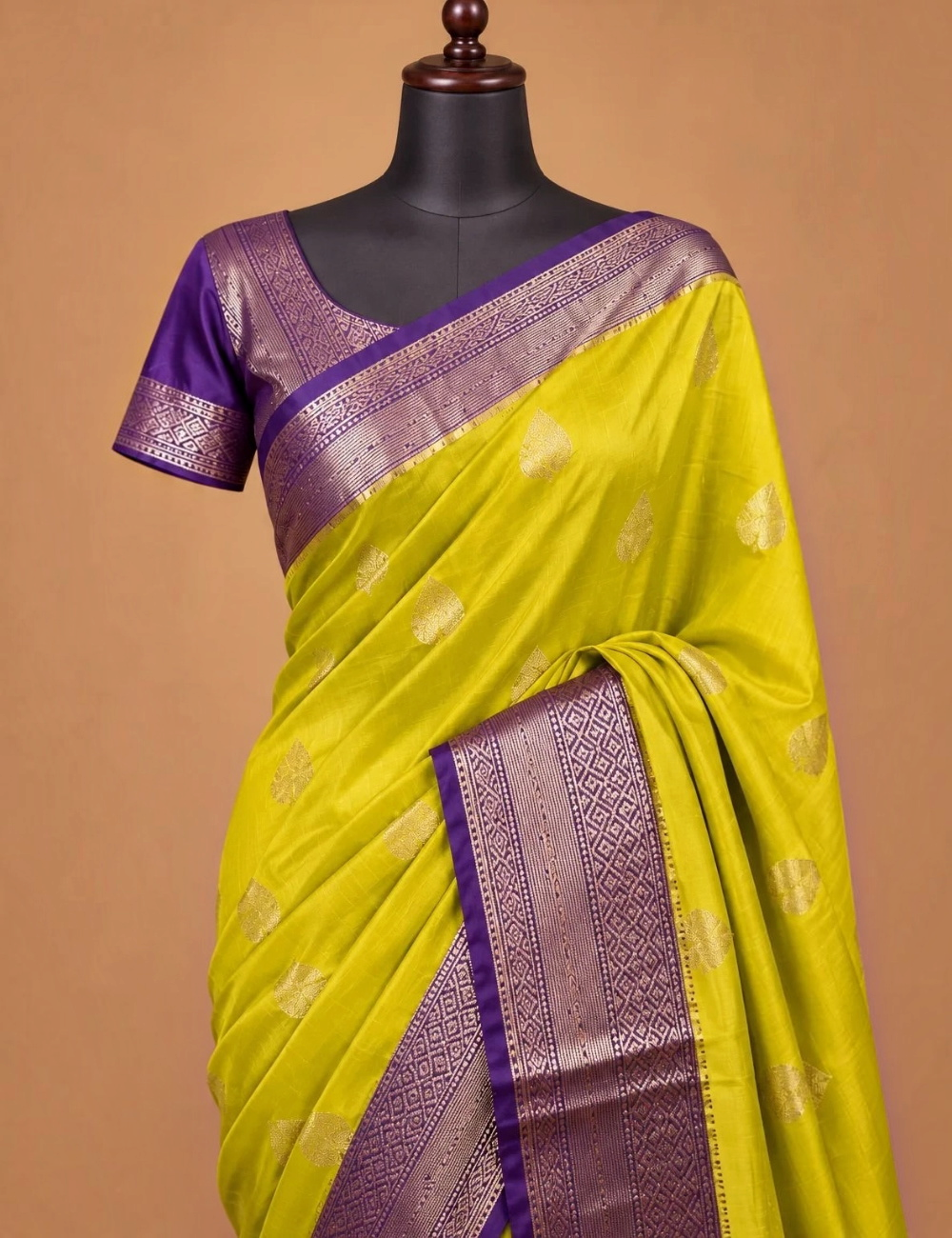 House Of Paramya mustard yellow Assam silk saree with gold leaf buti motifs and a purple border with geometric weave.