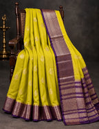 House Of Paramya mustard yellow Assam silk saree with woven gold leaf motifs and a purple border with metallic weave.