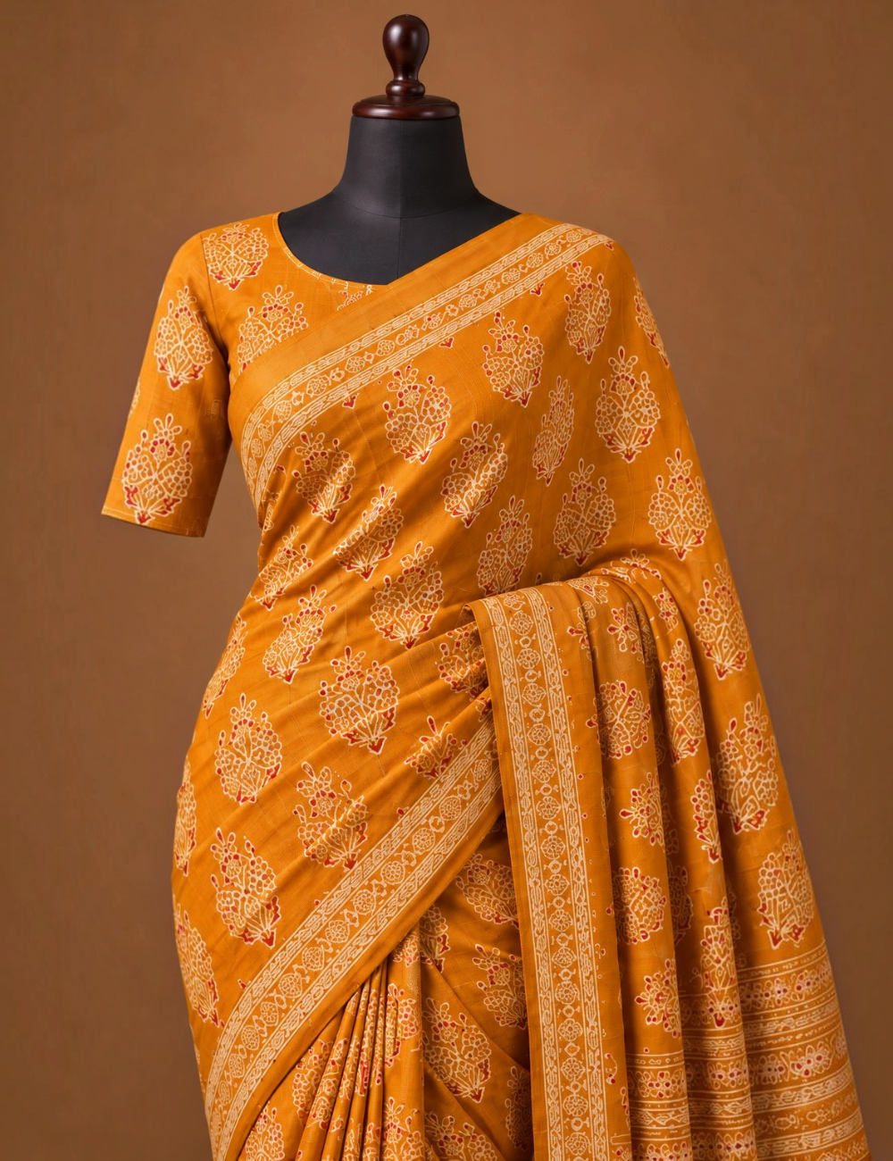House Of Paramya mustard modal silk saree with white and red Ajrakh block print and a gold zari border on a mannequin