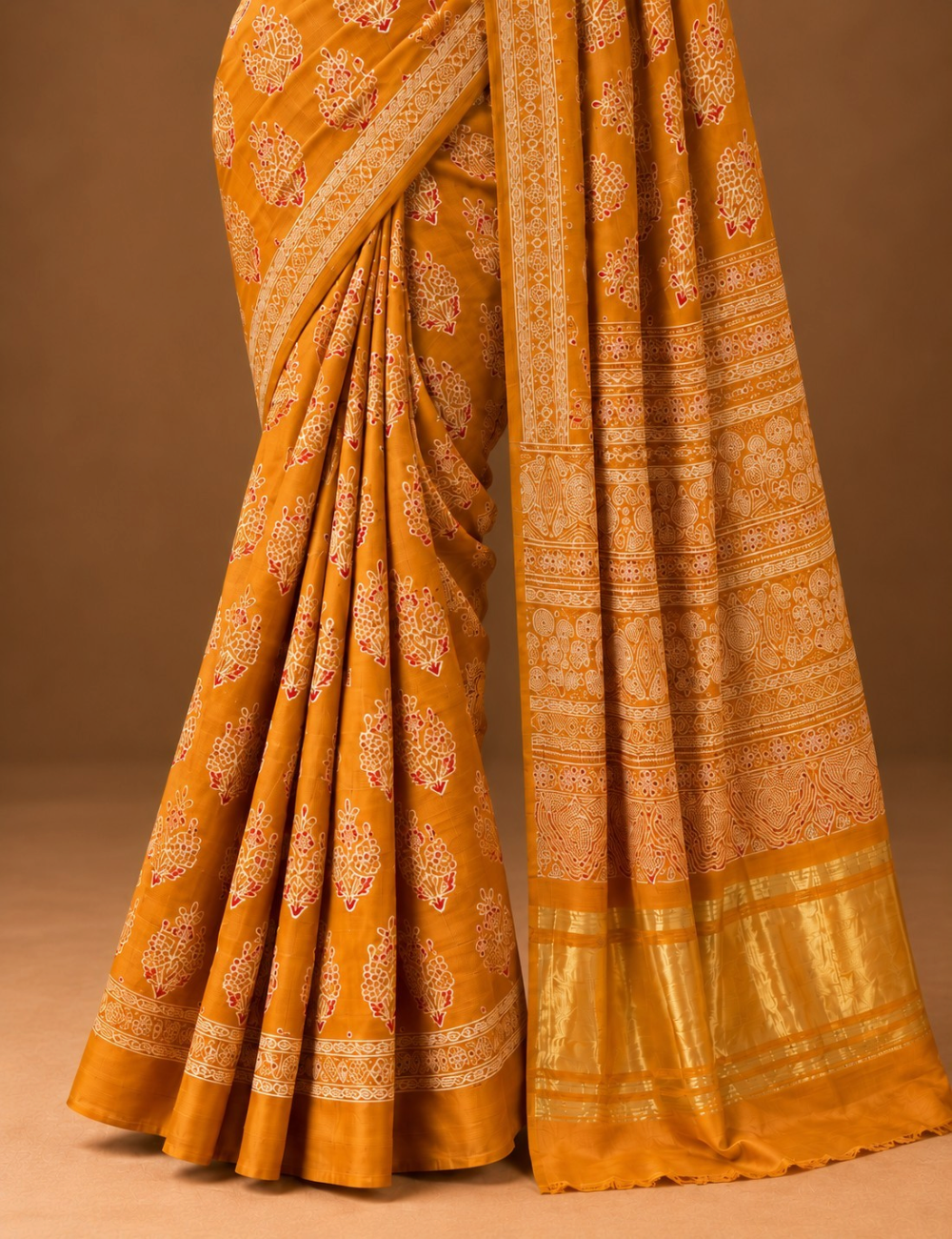 House Of Paramya mustard modal silk saree featuring intricate white and red Ajrakh block prints and a gold zari border.