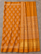 House Of Paramya mustard modal silk saree featuring intricate white and red Ajrakh block prints and a gold zari border.
