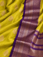 House Of Paramya mustard yellow Assam silk saree with gold leaf buti motifs and a purple border with metallic weave.