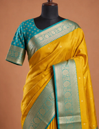 House Of Paramya mustard yellow Kanchipuram silk saree with turquoise blue blouse and gold zari floral border