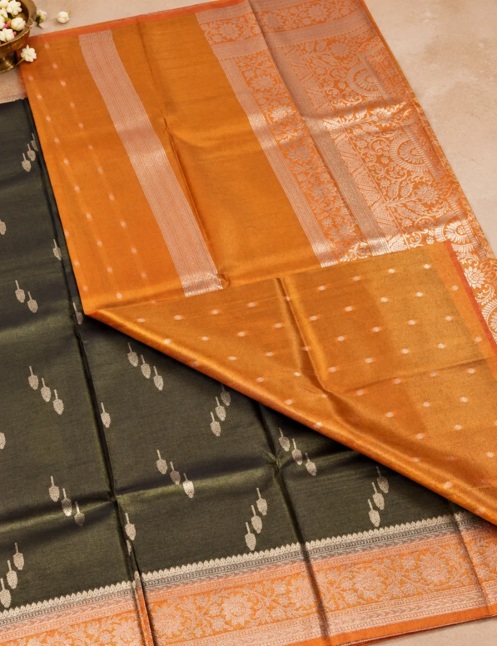 House Of Paramya olive gold tissue silk saree featuring nature-inspired woven motifs and a floral zari border.