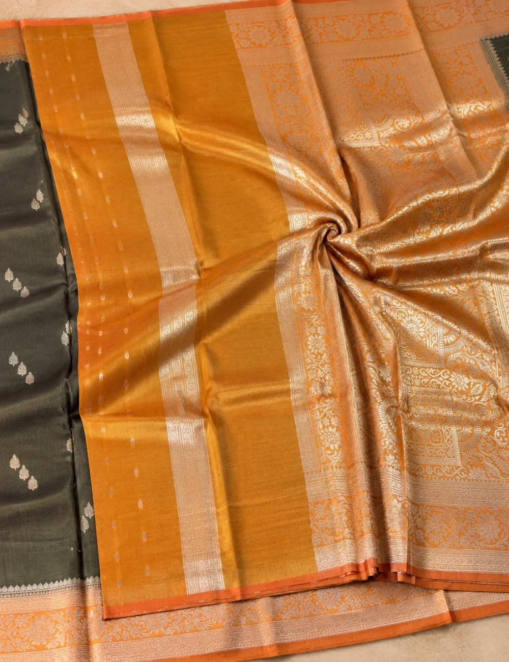 House Of Paramya olive gold tissue silk saree with shimmering nature-inspired motifs and a floral zari border.